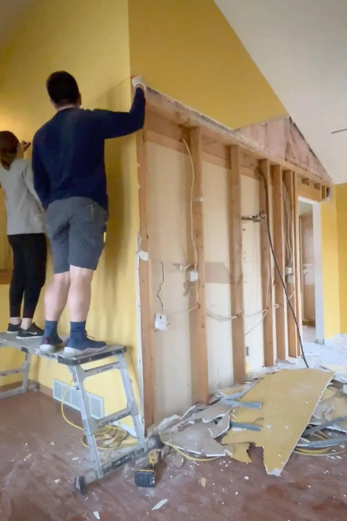 Removing drywall during kitchen remodel.
